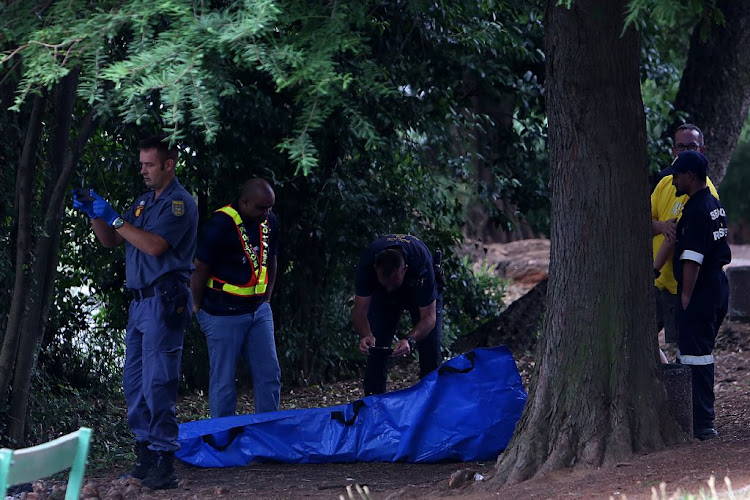 Police at the scene where a body was found floating in the Emmarentia Dam in Johannesburg on November 26 2018.