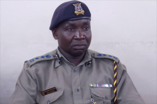 hands full: Mbeere South police boss Mathew Ekakoro at Kiritiri Market on Friday