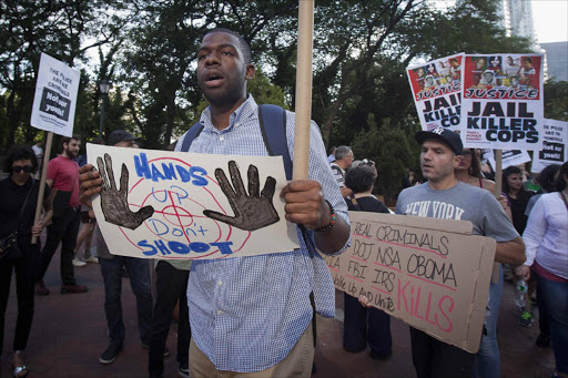 Protesters carry signs during a protest against the police in Ferguson, Missouri, in the Manhattan borough of New York. REUTERS