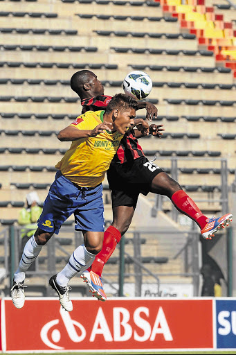 Maritzburg United's Morne David heads the ball away from Clayton Daniels of Mamelodi Sundowns during the sides' PSL match at Lucas Moripe stadium on Sunday Picture: LEE WARREN/GALLO IMAGES