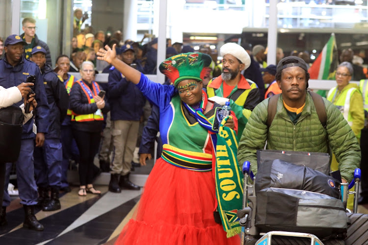 Mama Joy waves at fans who welcomed the South African rugby team back home.