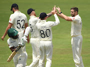 England bowler Chris Woakes (right) is congratulated by teammates after taking the wicket of Sizwe Masondo on day two of the practice match against a CSA Invitation XI in Benoni on Wednesday.