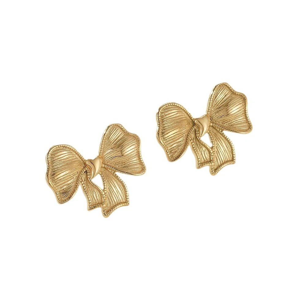 Boucles d'oreilles en acier titane en forme d'arc pour femmes, coulée dorée, mode. Élégance et légèreté pour toutes les occasions, un accessoire indispensable.