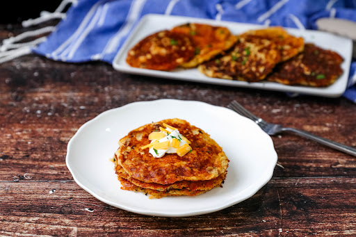 Bacon Cheddar Mashed Potato Cakes on a plate.