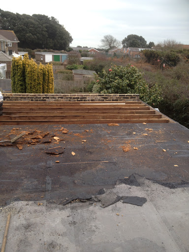 existing felt and rotten decking being removed.