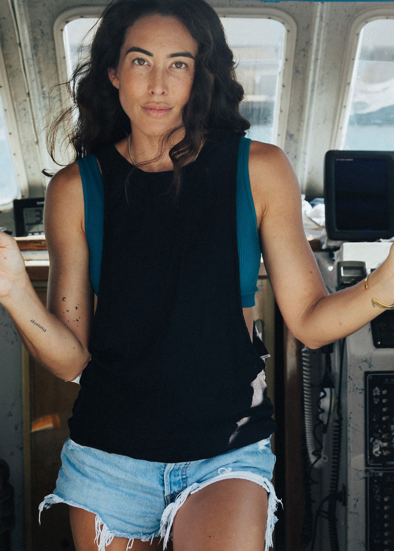 Chelsea Yamase standing inside her father's fishing boat 