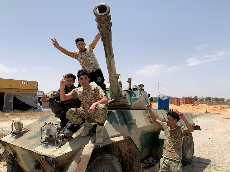 Turkey, with the second largest military in NATO, backs the internationally recognised GNA government in Libya's conflict while eastern Libyan commander Khalifa Haftar is backed by the United Arab Emirates, Egypt and Russia. Fighters loyal to Libya's internationally recognised government celebrate after regaining control over the city, in Tripoli, Libya, on June 4, 2020.