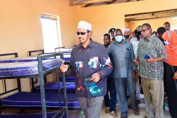 Eldas MP Adan Keynan inspects newly opened dormitory at Eldas Secondary school on Tuesday.