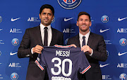 Lionel Messi poses with his jersey next to President Nasser Al Khelaifi after the press conference of Paris Saint-Germain at Parc des Princes on August 11, 2021 in Paris, France. 