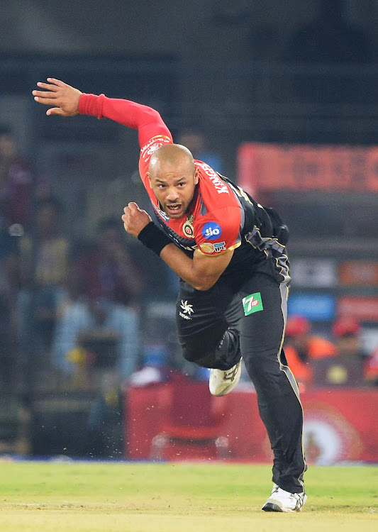 Royal Challengers Bangalore bowler Tymal Mills bowls against Kings XI Punjab during a 2017 Indian Premier League (IPL) Twenty20 match at the Holkar Stadium in Indore