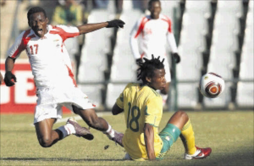 Under-23 player Thamsanqa Sangweni tackles Benin's Abdel Svanon during yesterday's Olympic qualifier at Rand Stadium which SA won 5-1