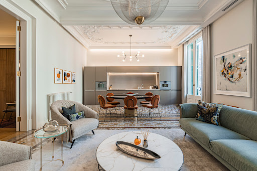Modern living room with open plan designer kitchen in this luxury property for sale in Barcelona ($3,776,439)