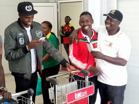 Juma Walukhu (R) embraces his son and national team men's volleyball libero Sam