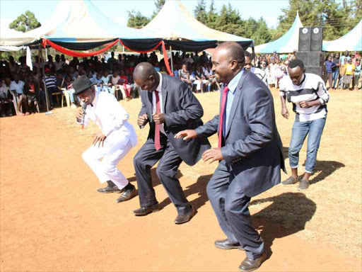 Uasin Gishu Governor Jackson Mandago and deputy Daniel Chemno join dancers during a youth concert at Jua Kali in Eldoret, December 12, 2017. /MATHEWS NDANYI