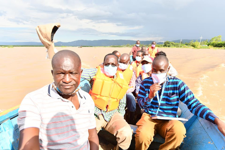 Kisumu Governor Anyang Nyong'o (C) during food donations to flood victims in Nyakach subcounty