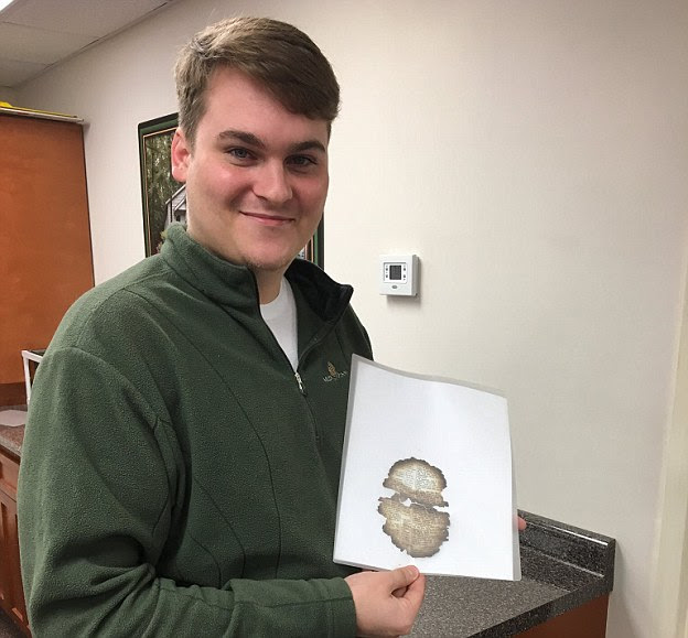 Isaac McCord, 24, says he was helping his coworkers clean up Dollywood, Dolly Parton's theme park, when he found the burned Bible page