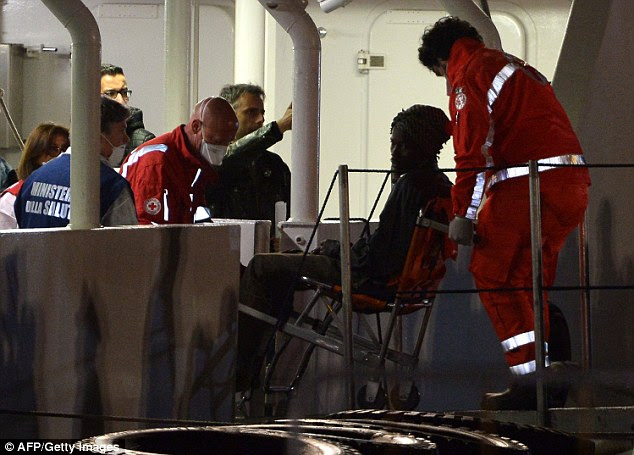 Taken to safety: An unknown survivor of the Mediterranean migrant tragedy is wheeled off an Italian coastguard ship in the Sicilian city of Catania