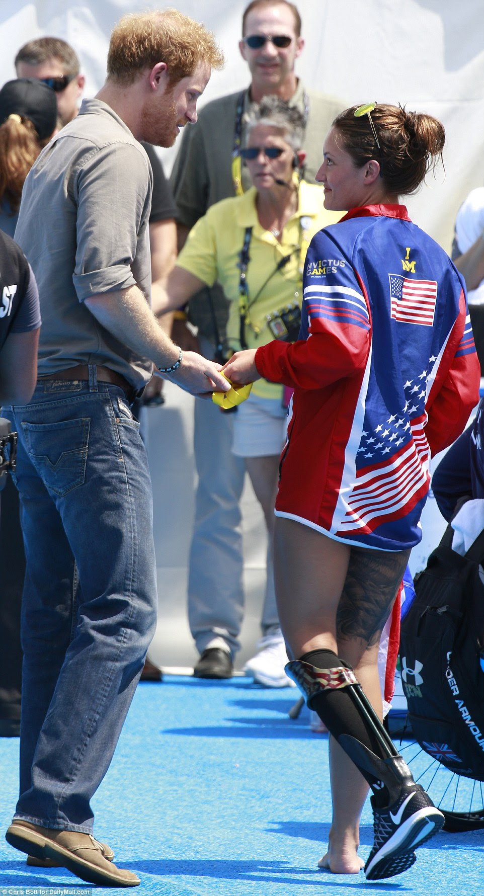 Prince Harry was seen sharing an emotional moment with US athlete Elizabeth Marks on the third day of the Invictus games in Orlando Florida, as she returned her gold medal for the 100m freestyle to him so that he could pass it on to Papworth Hospital in the UK
