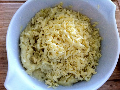 Grated Aged Sharp Cheddar Cheese Added to Poatoes