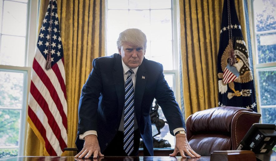 President Donald Trump at his desk in the Oval Office.