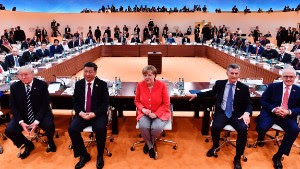 TOPSHOT - (L-R) US President Donald Trump, China's President Xi Jinping, German Chancellor Angela Merkel, Argentinia's President Mauricio Macri and Australia's Prime Minister Malcolm Turnbull turn around for photographers at the start of the first working session of the G20 meeting in Hamburg, northern Germany, on July 7.
Leaders of the world's top economies will gather from July 7 to 8, 2017 in Germany for likely the stormiest G20 summit in years, with disagreements ranging from wars to climate change and global trade. / AFP PHOTO / AFP PHOTO AND POOL / John MACDOUGALL        (Photo credit should read JOHN MACDOUGALL/AFP/Getty Images)