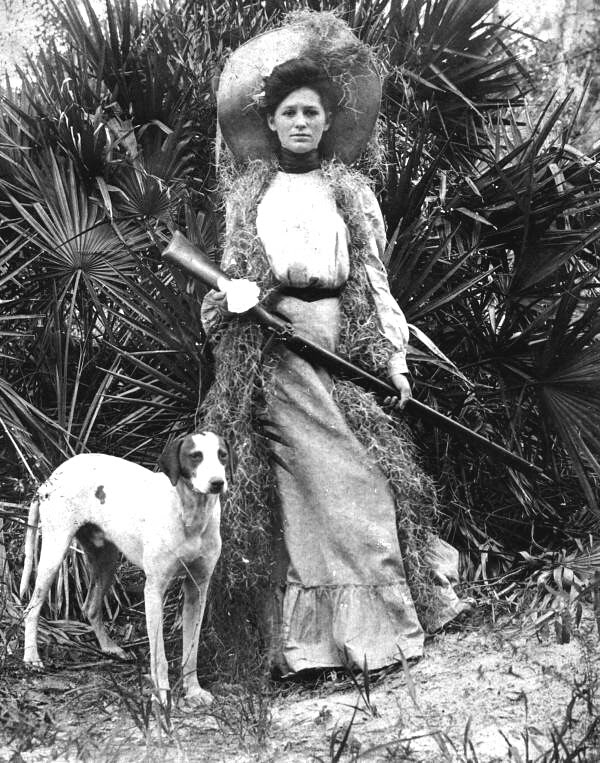 Woman with rifle and dog