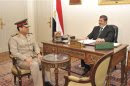 File handout picture of Egypt's President Mursi meeting with Defence Minister Fattah in Cairo