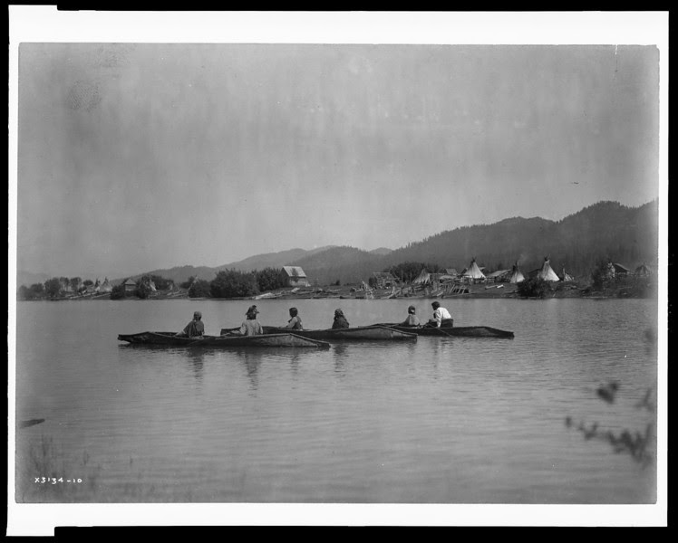 Description of  Title: Home of the Kalispel.  <br />Date Created/Published: c1910 March 11.  <br />Summary: Kalispel camp on a riverbank with tipis and frame houses, three canoes in water in foreground.  <br />Photograph by Edward S. Curtis, Curtis (Edward S.) Collection, Library of Congress Prints and Photographs Division Washington, D.C.