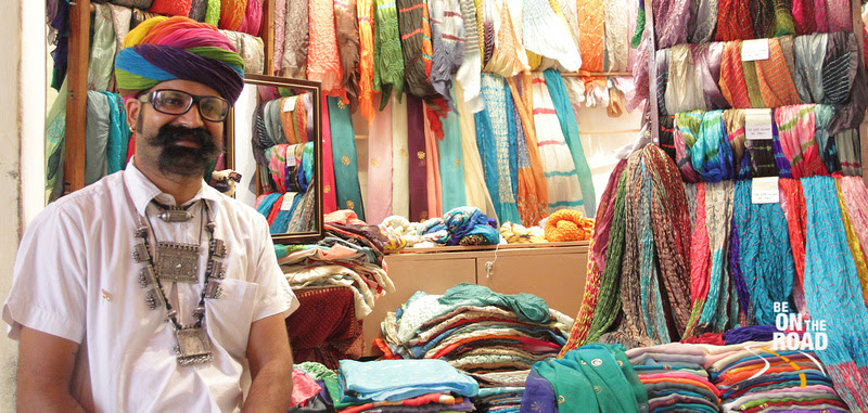 Rajsthani man with big moustache in front of his silk scarf shop at Jodhpur