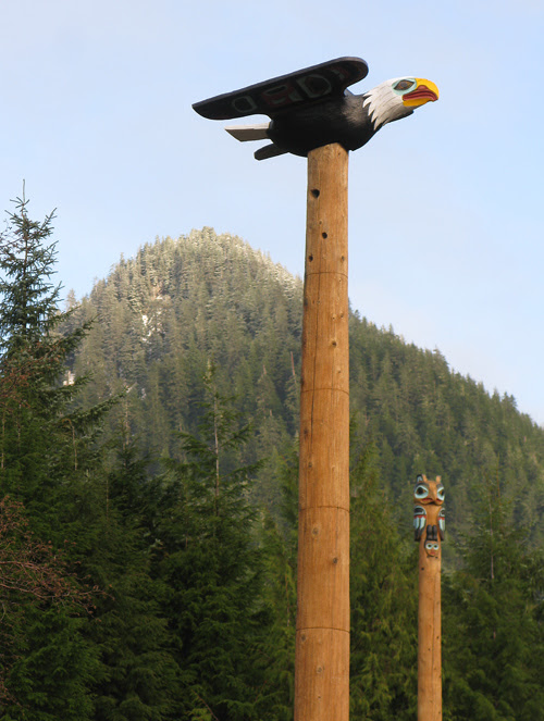 an eagle figure atop a totem pole in Saxman, Alaska