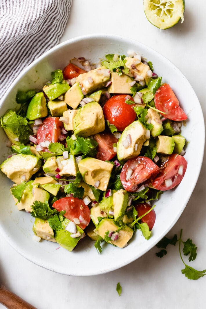 Easy Guacamole Salad - turn everyone's favorite dip into a salad! This avocado salad is sure to be a hit with everyone at potlucks, barbecues, or parties this summer! #summersalad #guacamole #guacamolesalad #deconstructedguacamolesalad #avocadosalad #tomatoavocadosalad | Littlespicejar.com Easy Guacamole Salad - turn everyone's favorite dip into a salad! This avocado salad is sure to be a hit with everyone at potlucks, barbecues, or parties this summer! #summersalad #guacamole #guacamolesalad #deconstructedguacamolesalad #avocadosalad #tomatoavocadosalad | Littlespicejar.com
