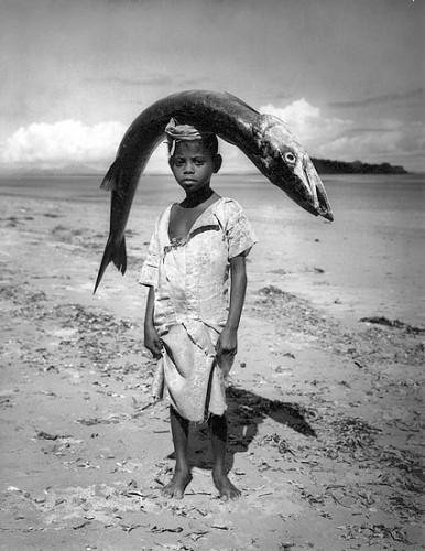 Boy carrying fish