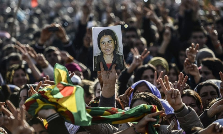 Kurdish people hold a picture of dead fighter during a celebration rally near the Turkish-Syrian border at Suruç on Tuesday