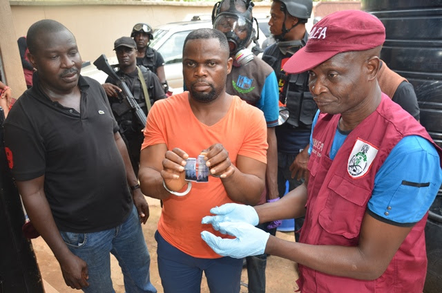 the suspect in the middle with ndlea officers during a   field test of the meth