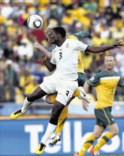 AERIAL DUEL: Asamoah Gyan and David Carney of Australia during the game that ended 1-1 on Saturday. Pic.SIMPHIWE NKWALI. 19/06/2010. © ST. Ghana vs Australia during the group stages of the 2010 FIFA World Cup qualifiers at Rustenburg. Asamoah Gyan(3) and David Carney during the game. The score is 1-1 at full time Picture: SIMPHIWE NKWALI/ 19/06/2010