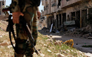 A member of Syrian forces of President Bashar al Assad stands guard in Jobar, eastern Ghouta, in Damascus, Syria April 2, 2018.