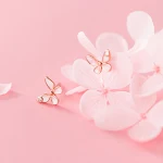 A pair of rose gold butterflie
