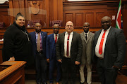 Members of the team who investigated the fatal beating of six men suspected of being involved in the killing of a security guard, which culminated in a hefty sentence for 14 suspects in the Cape high court.
 