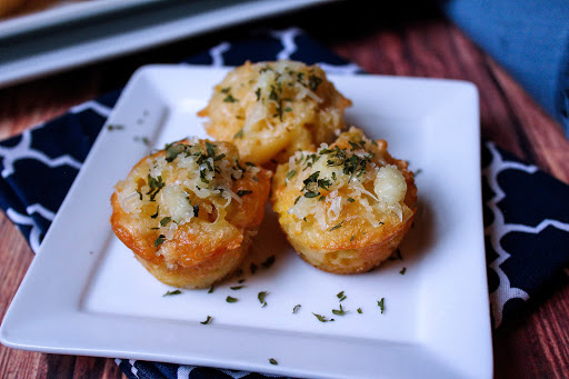 Three Mac and Cheese Bites on a plate.