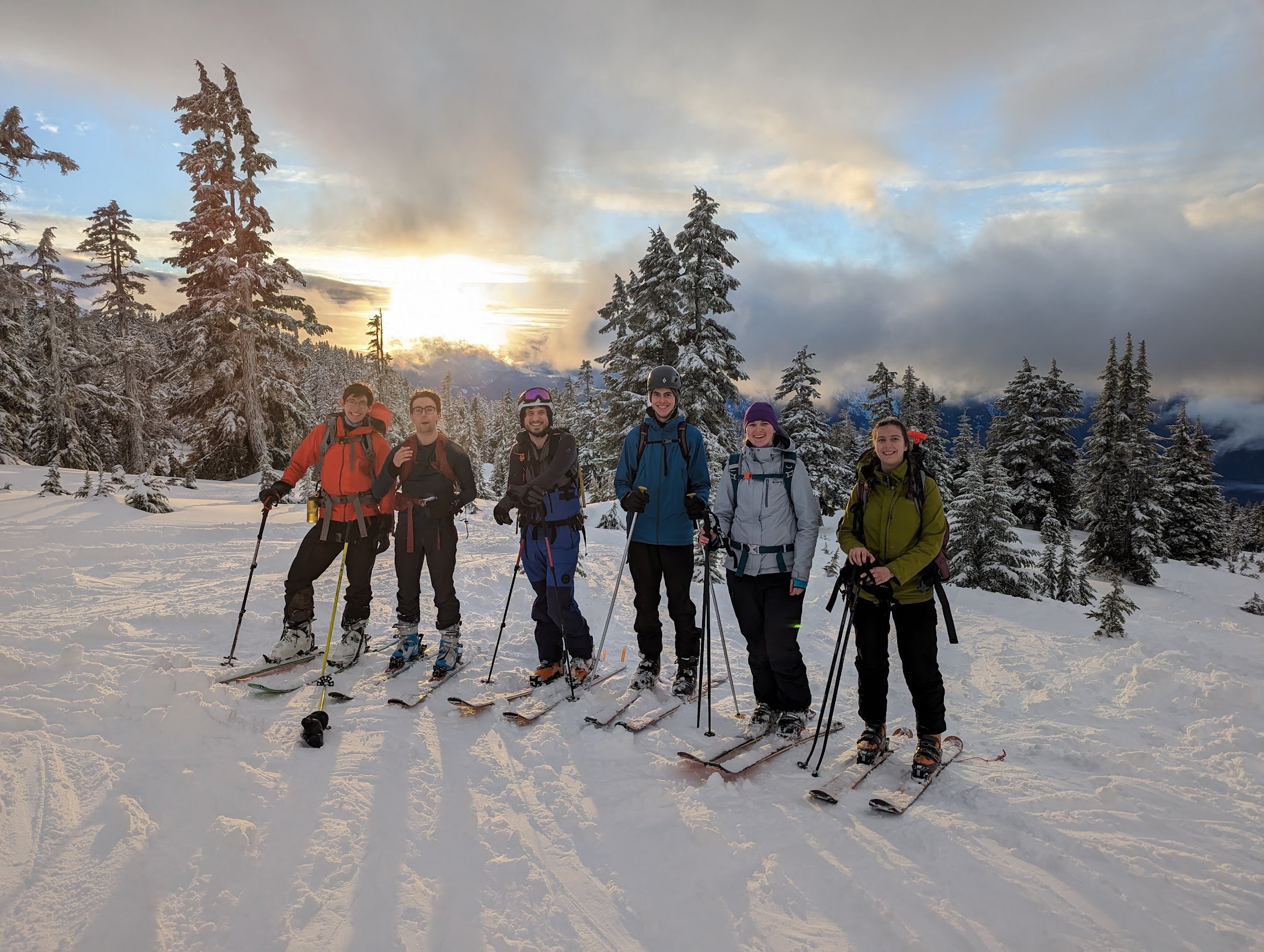 Happy skiers in the sunset