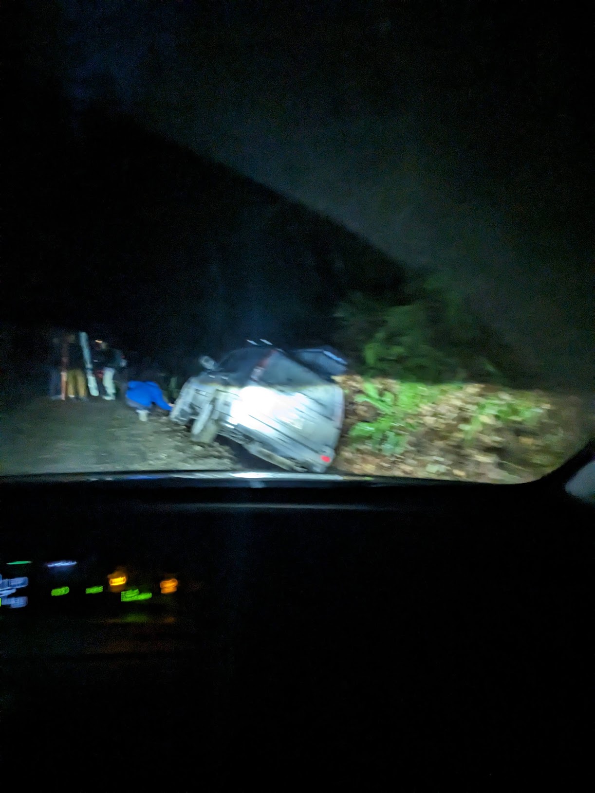 car in the ditch, at night