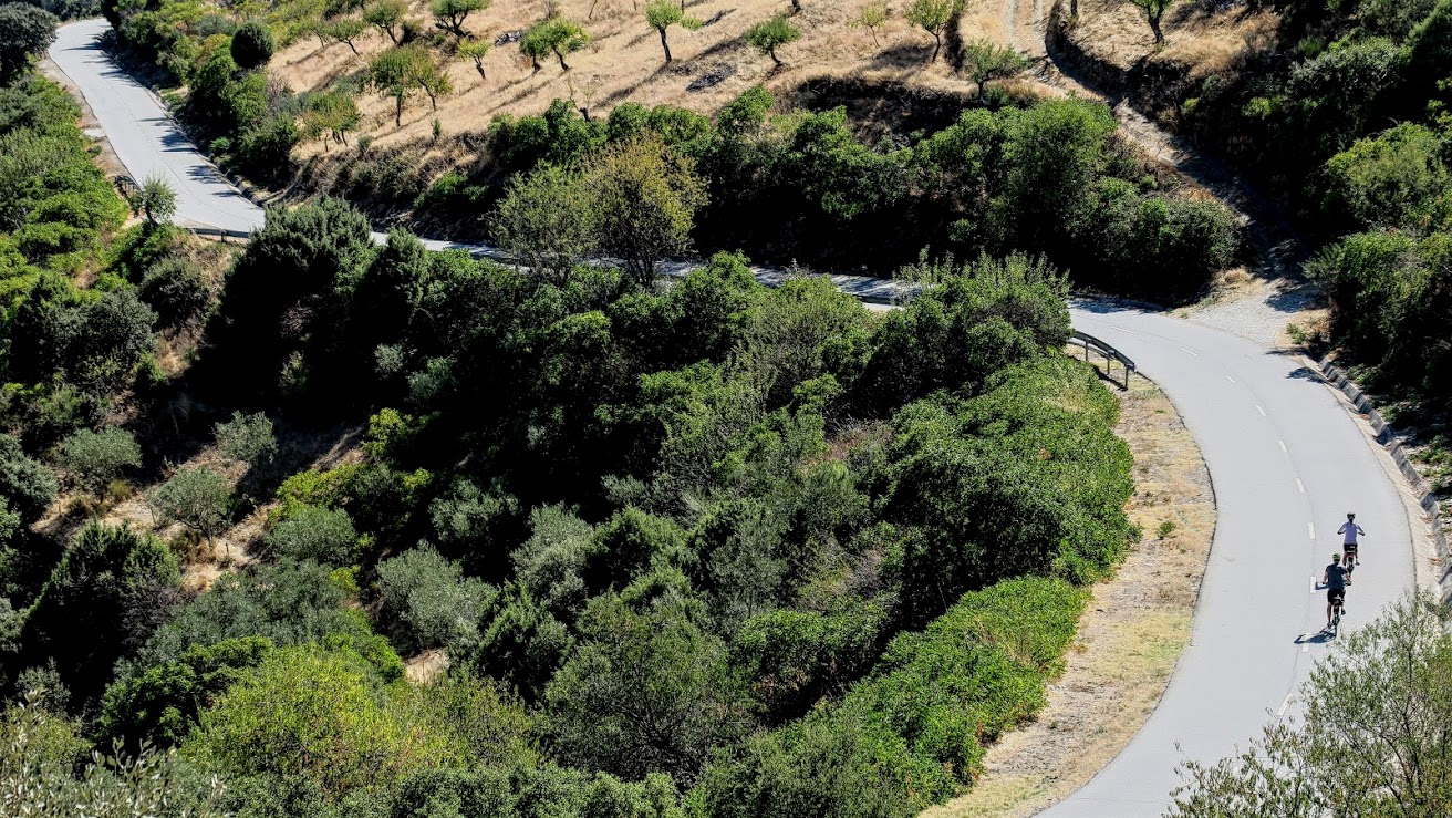 Couple cycling on a quiet scenic road in the Douro Valley