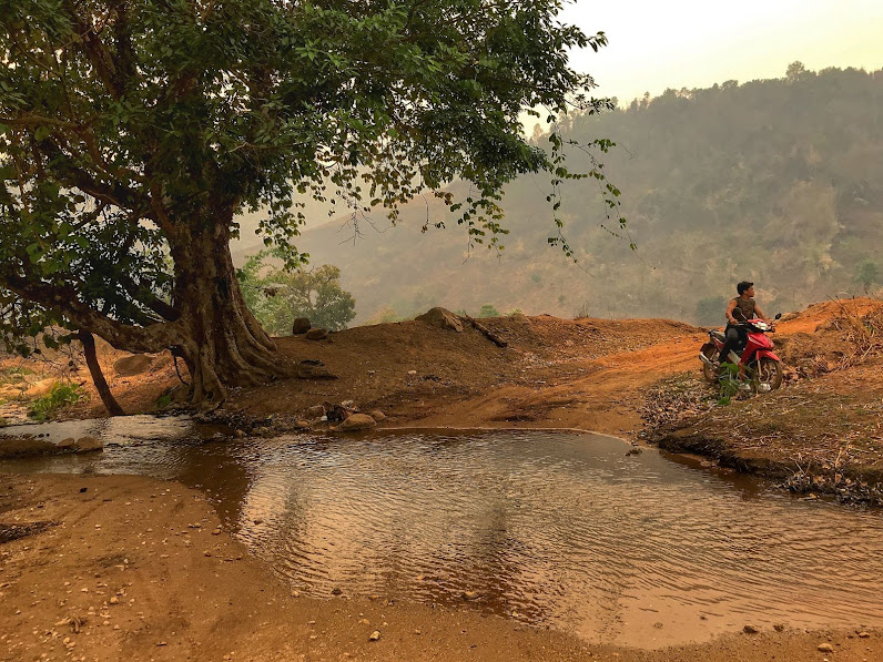 About to cross puddle with scooter in the middle of the road