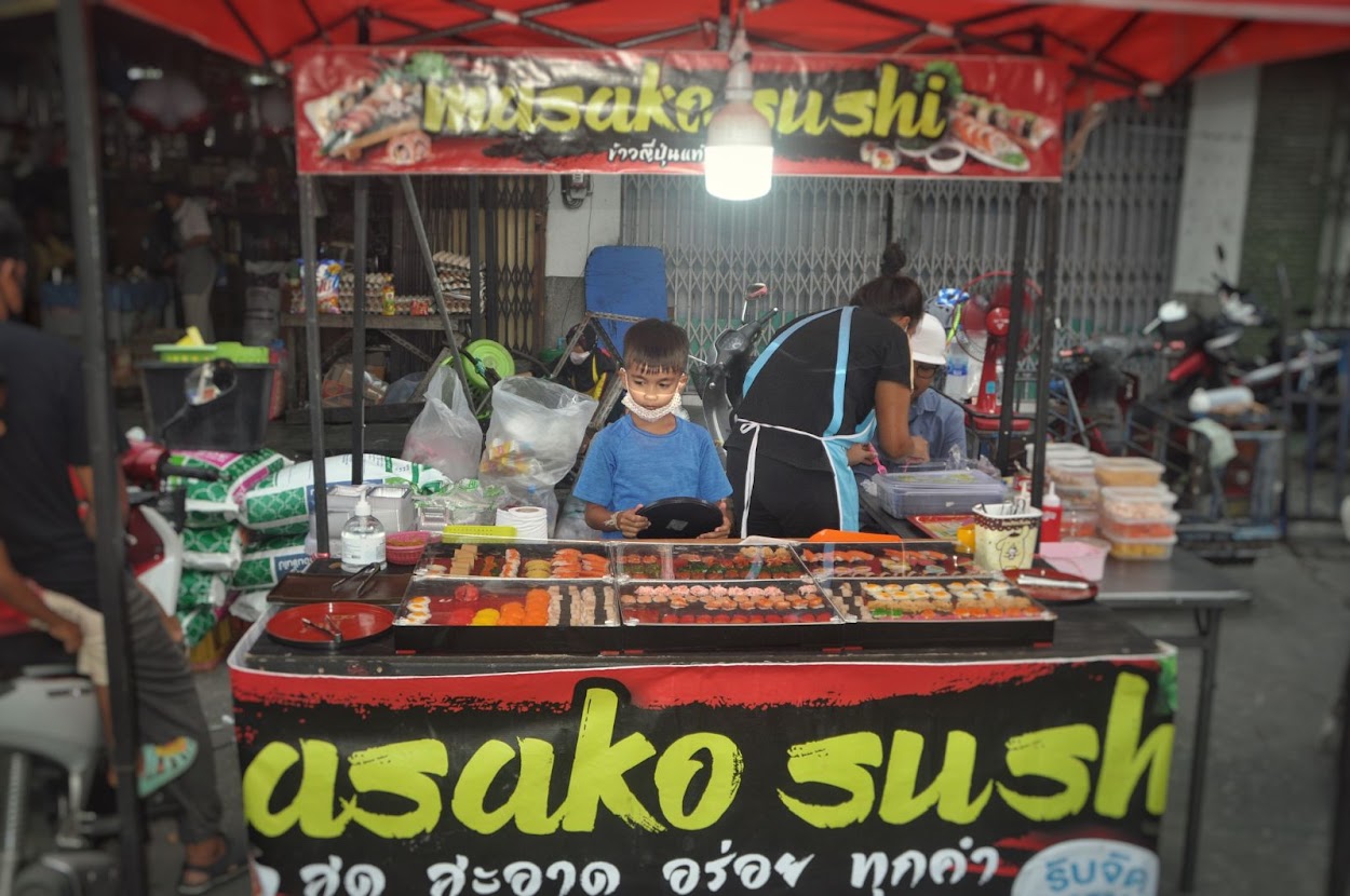 Pattani City
Pattani Province
Thailand 
Street food market
Child vendor
Meat sticks