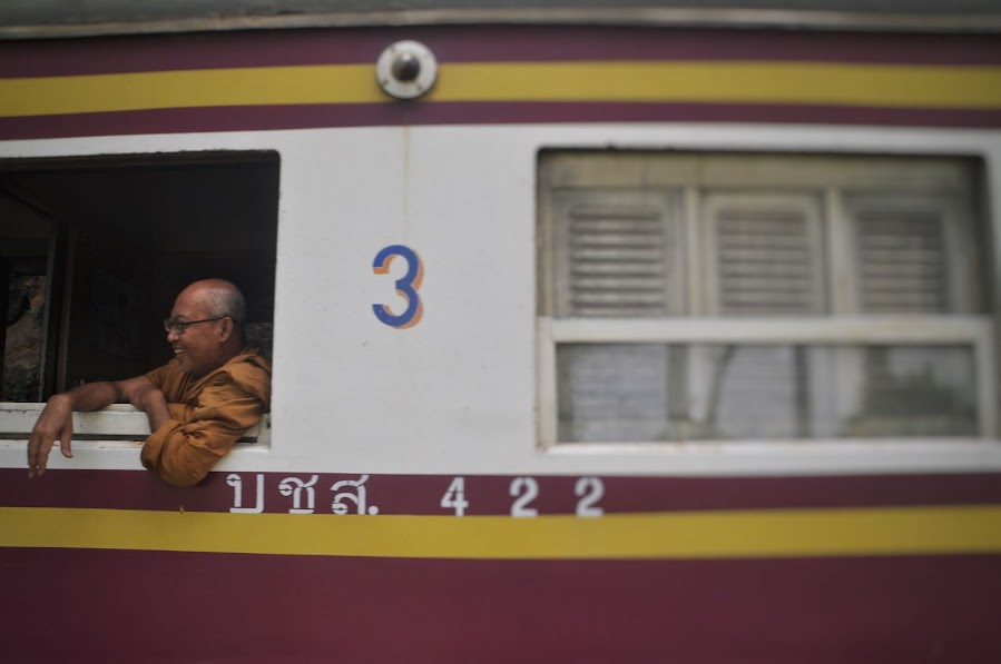 thai man on a train photo from window