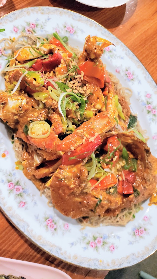 Gado Gado Singapore Chili Crab - whole wok fried Dungeness crab with chili-garlic and tomato gravy on sesame noodle and served with grilled pandan roll