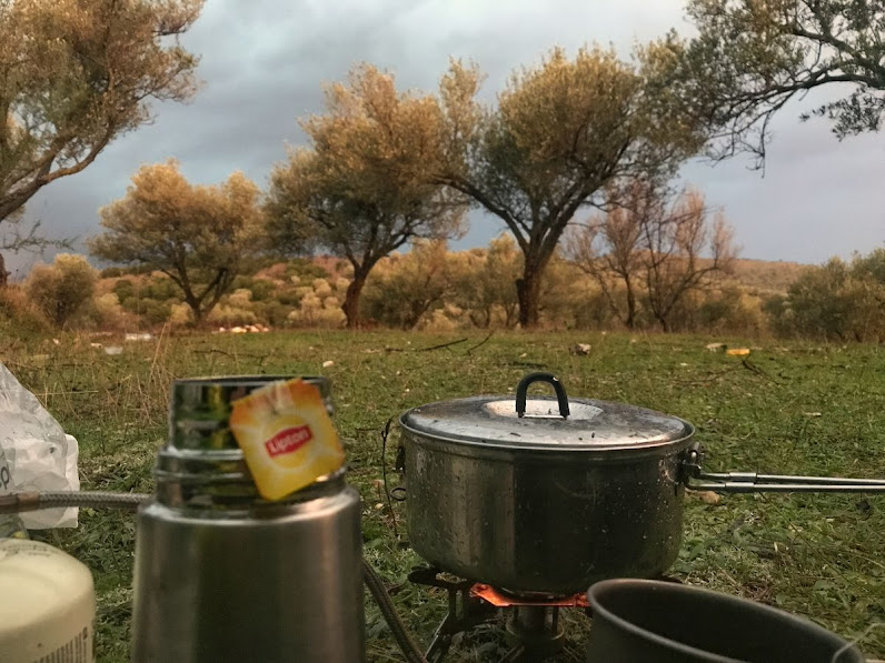 making tea on the grass below olive trees butrint national park albania camping