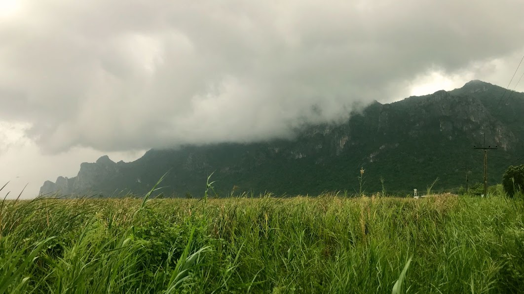 Clouds dissolving after the storm over green mountains