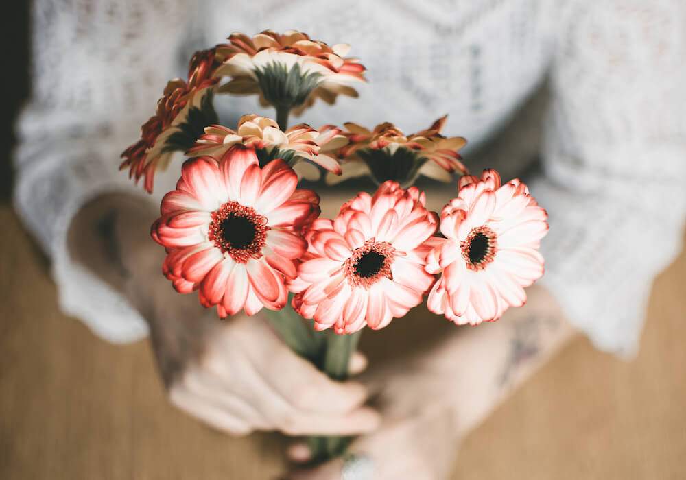 selective-focus-photography-of-person-holding-red-petaled.jpg