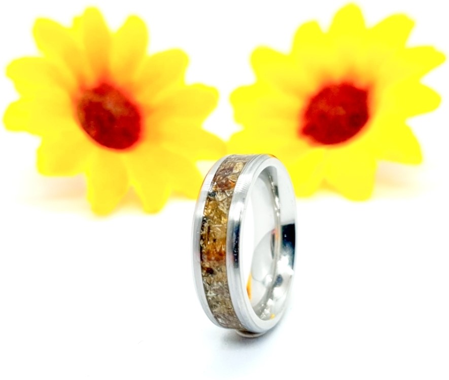 A memory keepsake ring from Marshall Memories with sunflowers in the background as decorations.